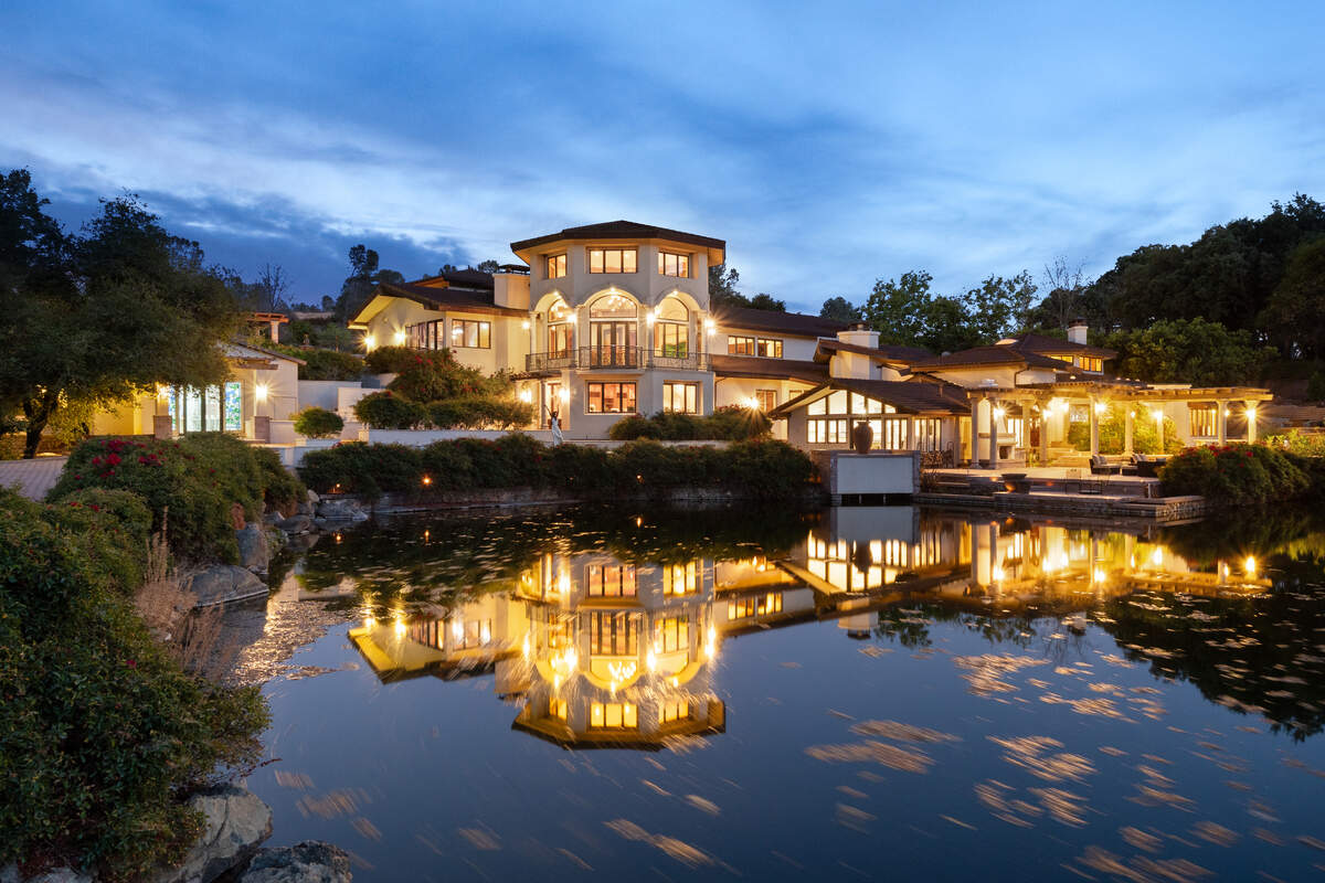 The newer, towering portion of the home overlooks the spring-fed pond, a central feature of the estate that was expanded to roughly twice its original size and stocked with bass and bluegill.